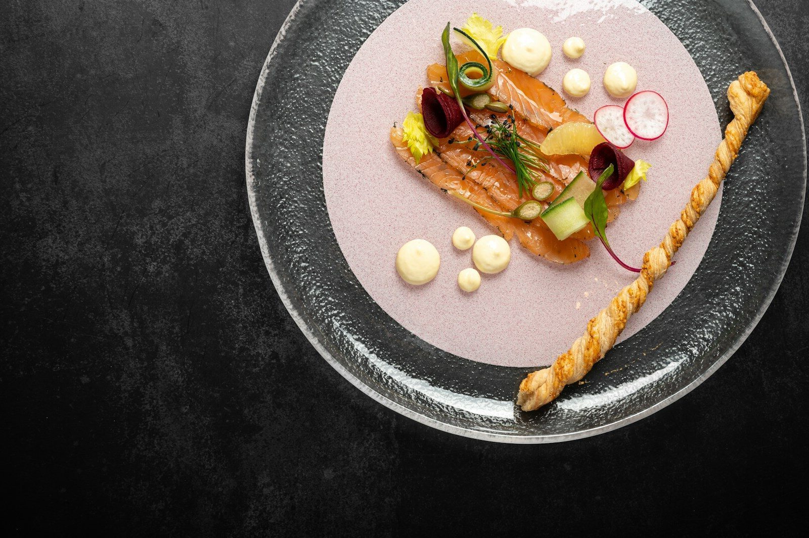 a plate of food on a black table