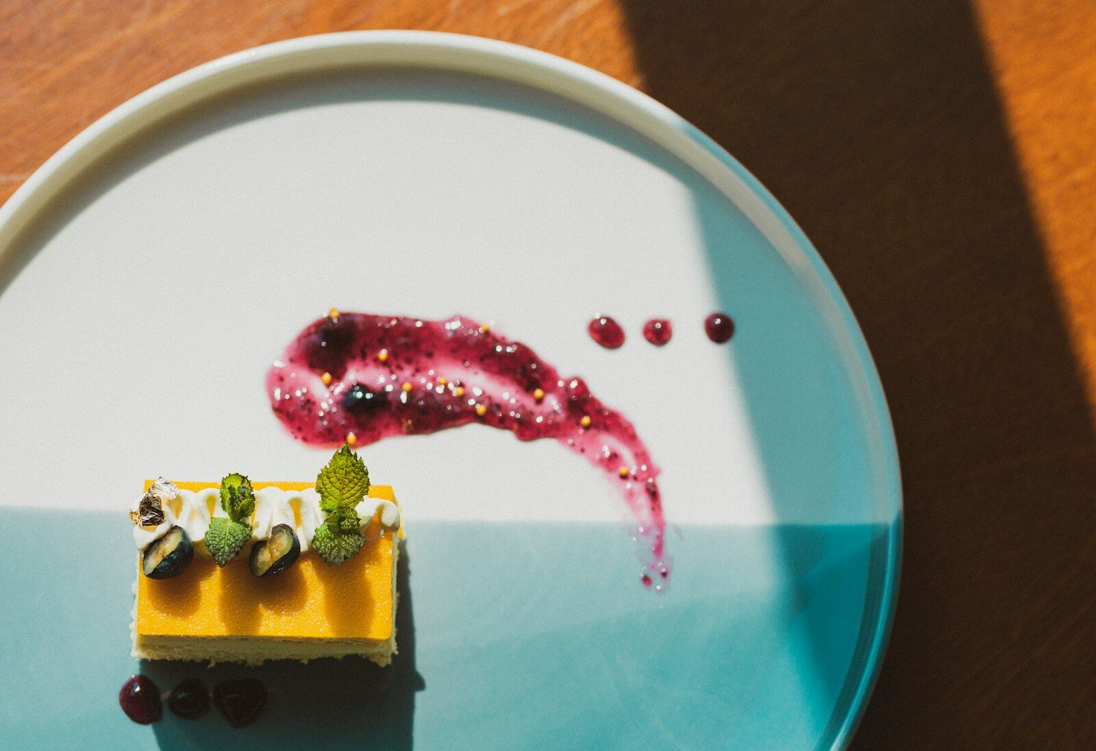yellow and pink cake on blue and white ceramic plate